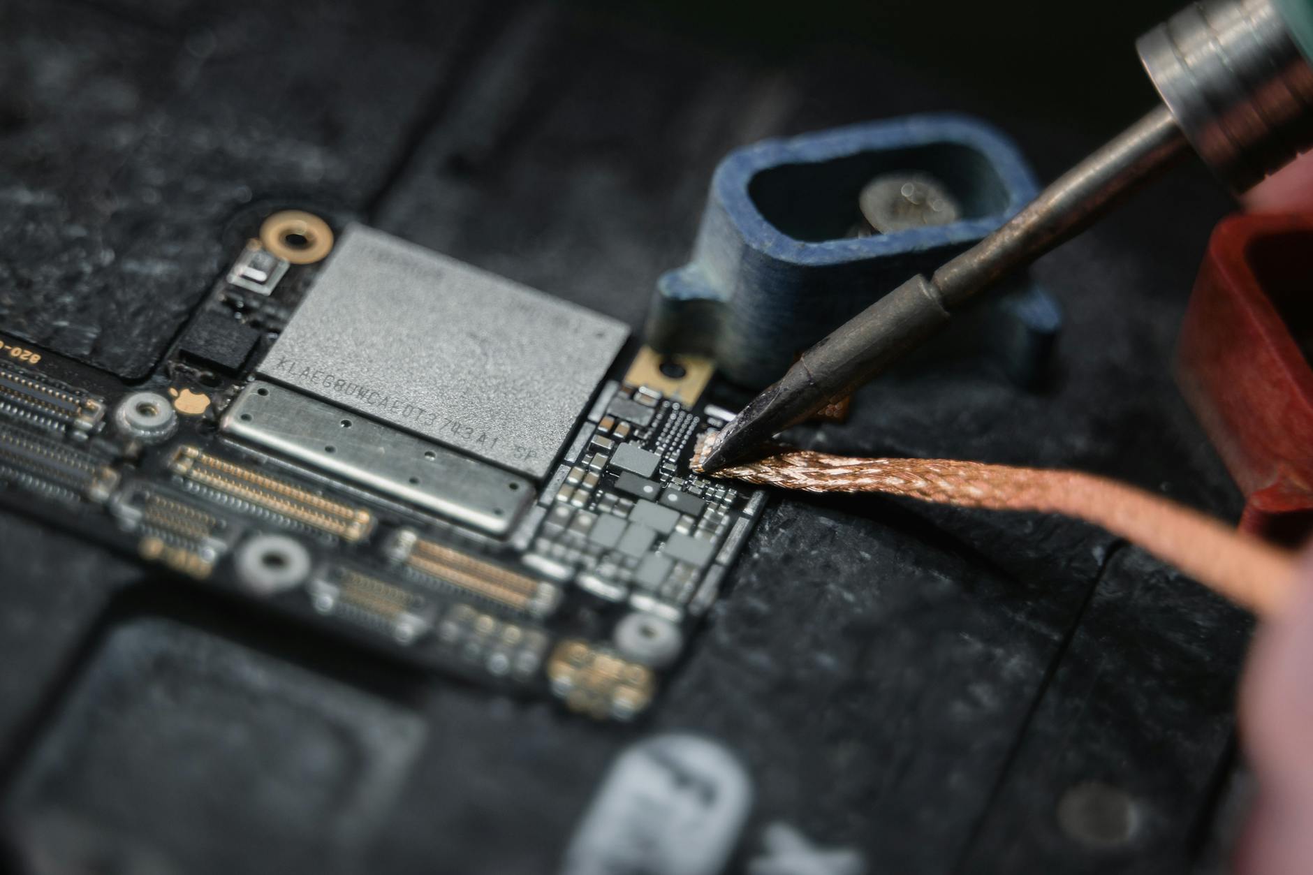 a wire being soldered on the motherboard
